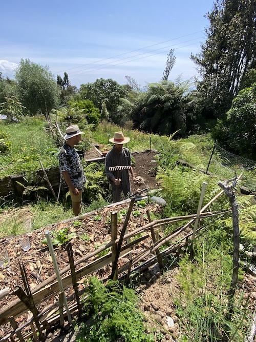 A man building a garden structure in the bush