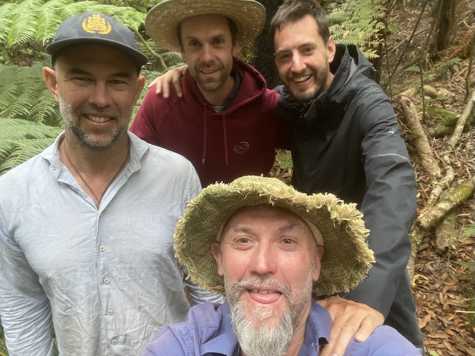Four men wearing hats, group photo from the Gaian Mens Bridge House event