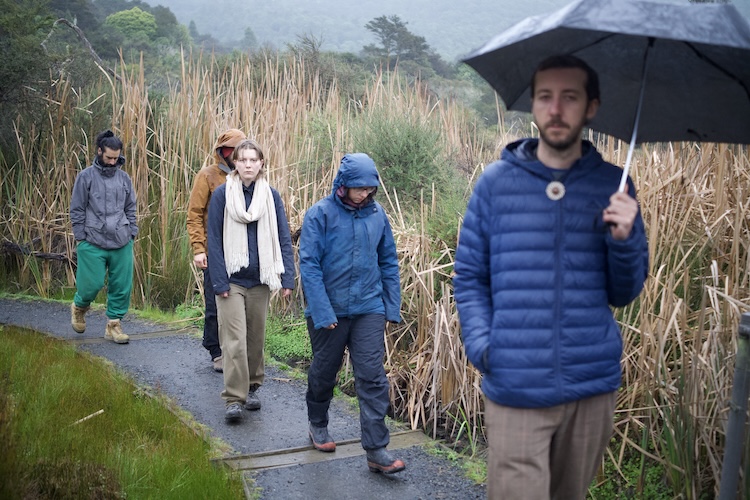 Three people walking a trail during the Momentum gathering
