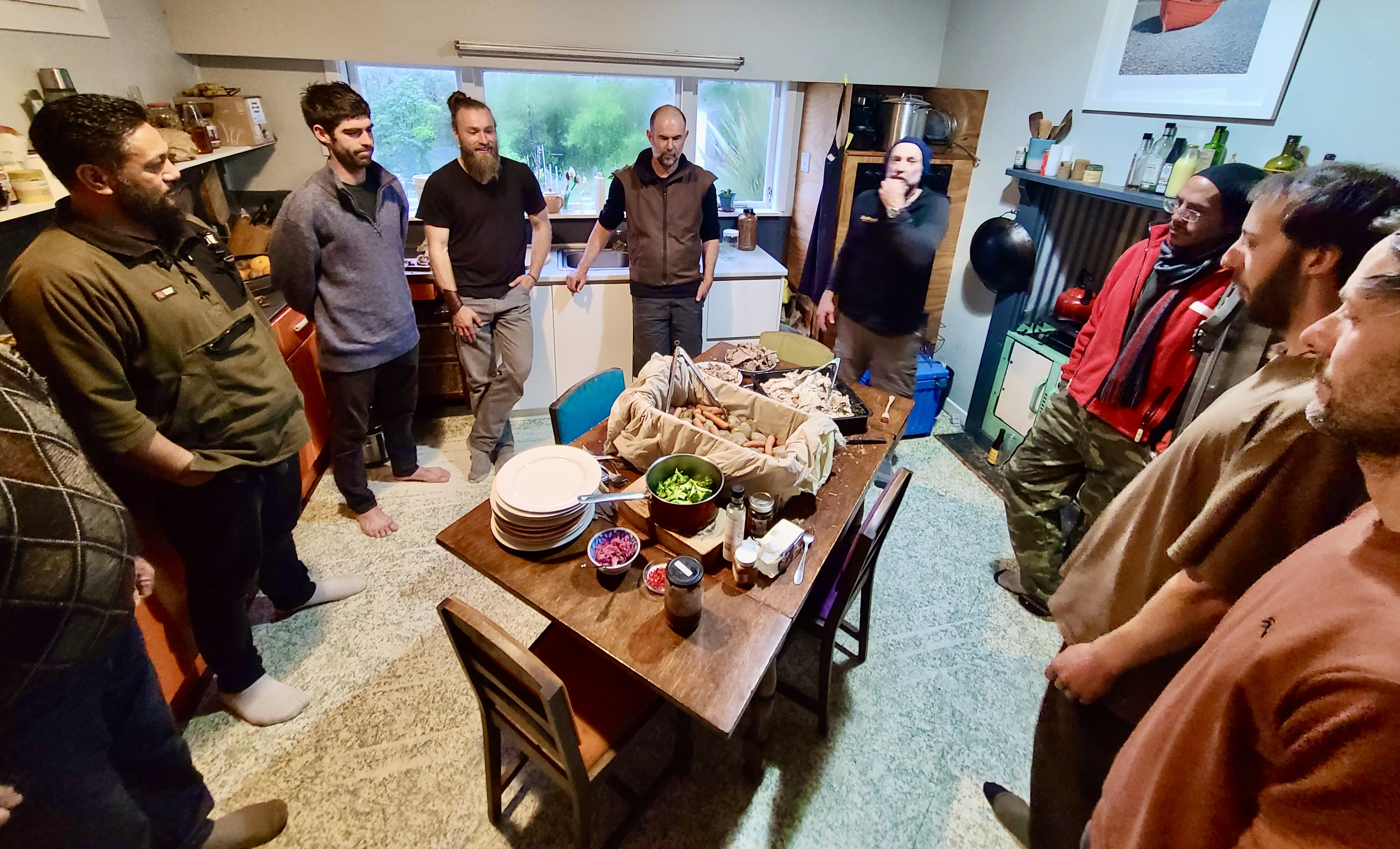 Group of men gathered around a table indoors