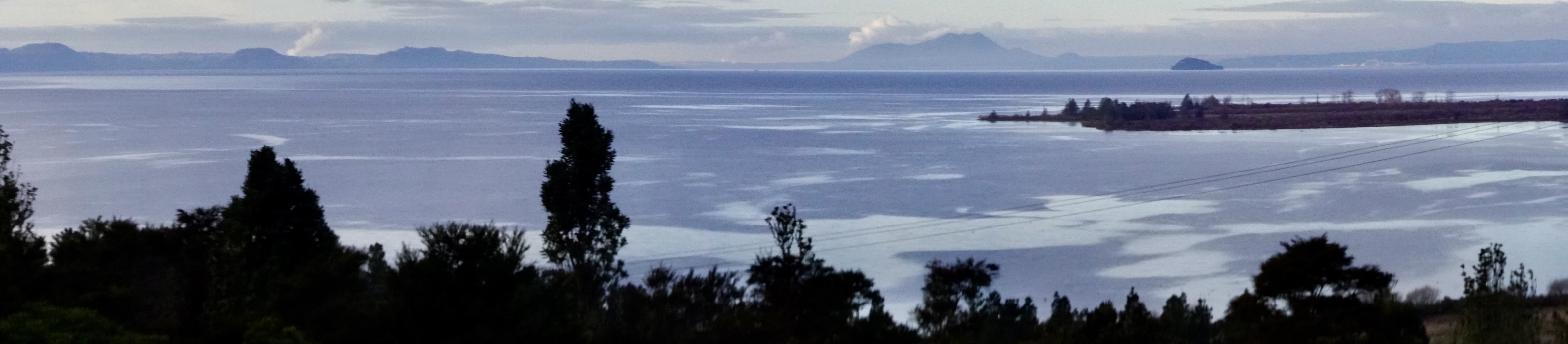 Panoramic view of Lake Taupo and surrounding mountains